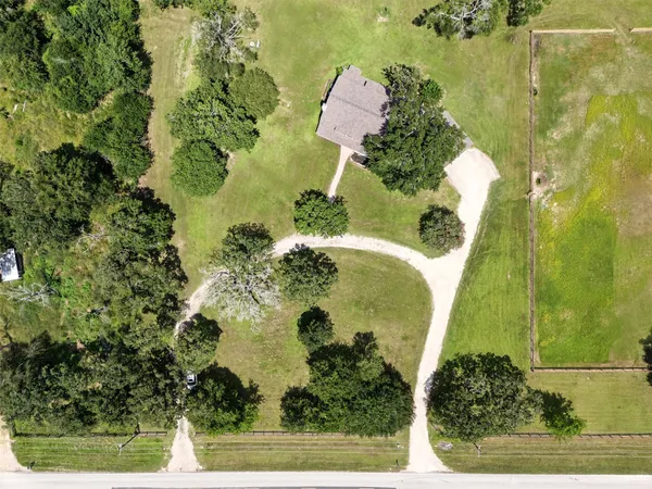 an aerial view of a residential houses with swimming pool