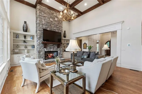 a living room with furniture fireplace and a flat screen tv