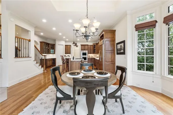 a kitchen with stainless steel appliances granite countertop a stove and a wooden floors