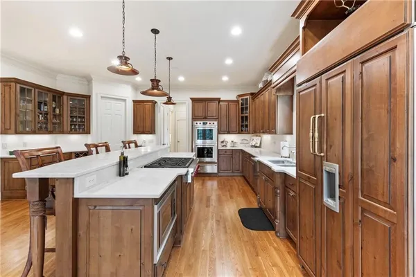 a kitchen with stainless steel appliances granite countertop a sink stove and refrigerator