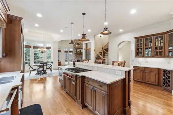 a kitchen with granite countertop white cabinets and a window
