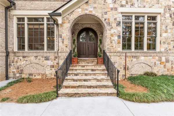 a front view of a house with a garden