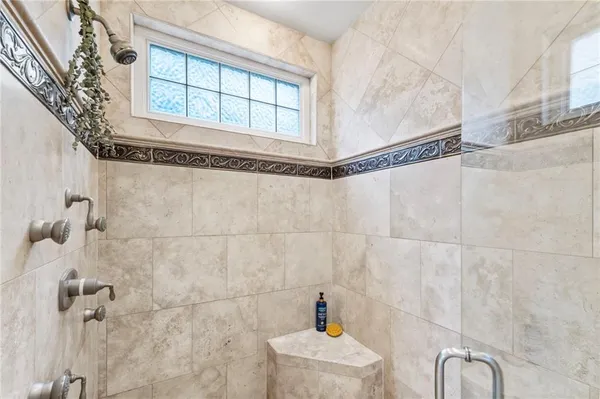 a view of a hallway with wooden floor and a bathroom