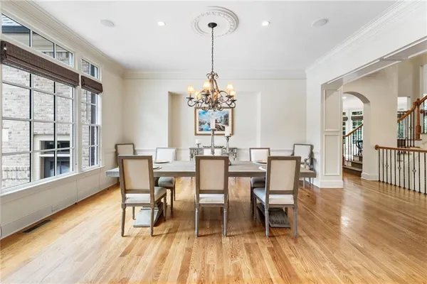 a view of a dining room with furniture wooden floor and chandelier