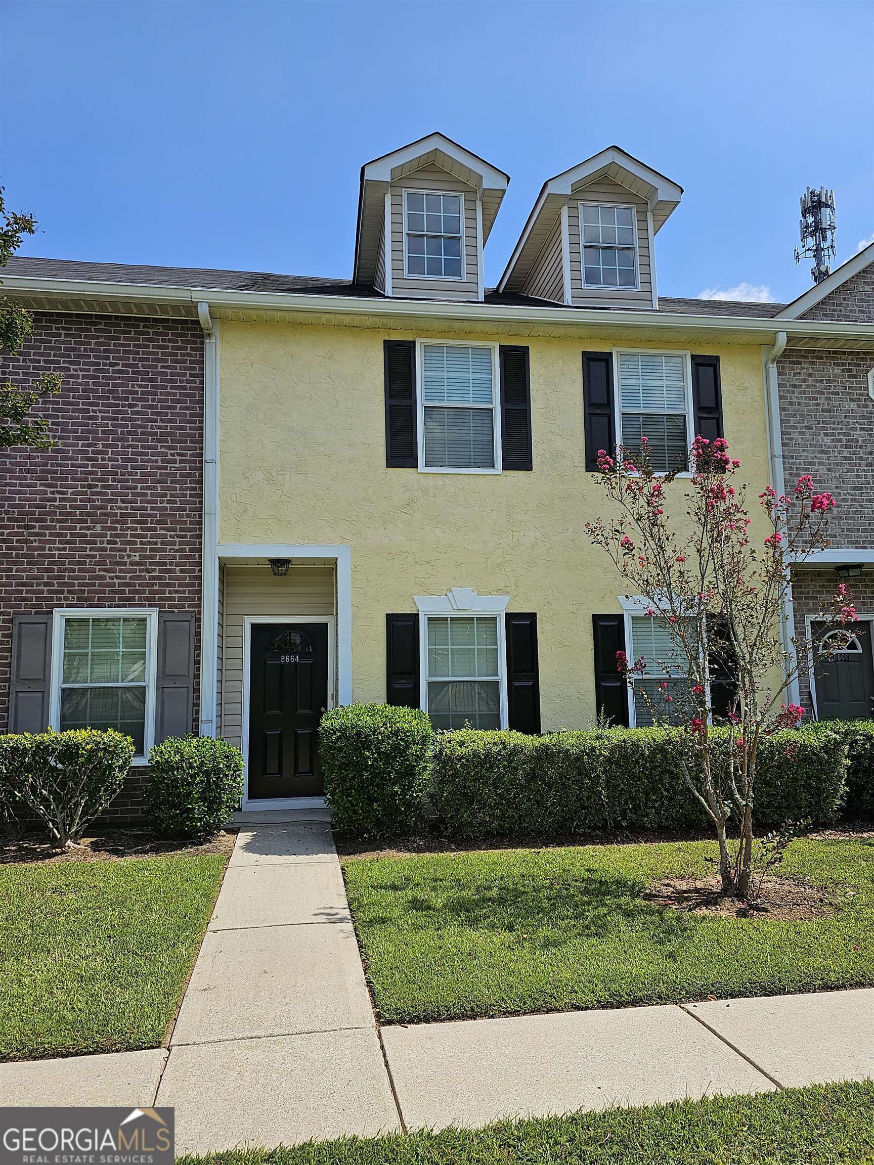 8664 Thomas Road Riverdale, GA 30274 - Photo 1 of 1 a front view of a house with a yard and potted plants