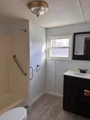 a bathroom with a sink toilet and shower
