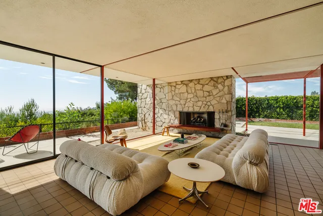 a living room with furniture and a floor to ceiling window