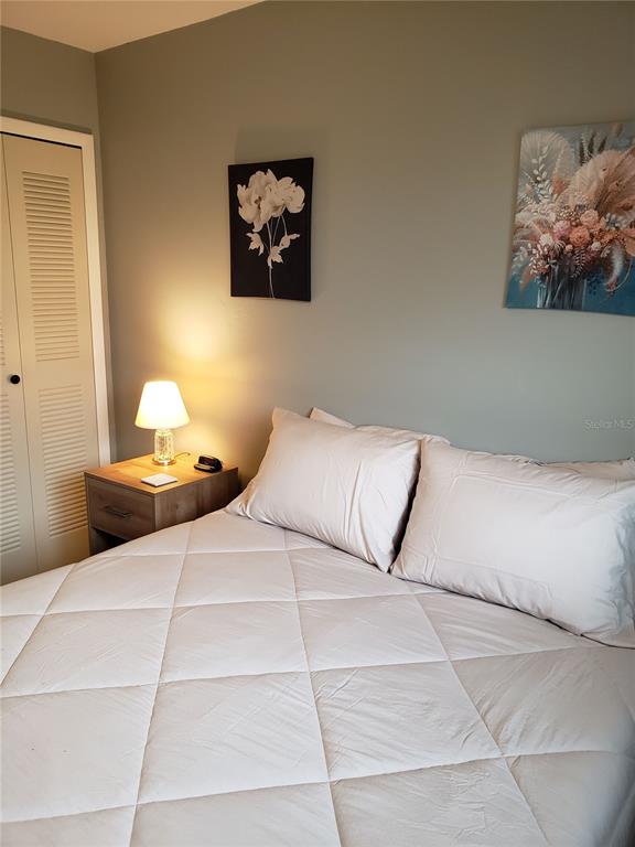 25225 Rampart Boulevard, Unit 1908 Punta Gorda, FL 33983 - Photo 11 of 15 a bedroom with a bed and a painting on the wall