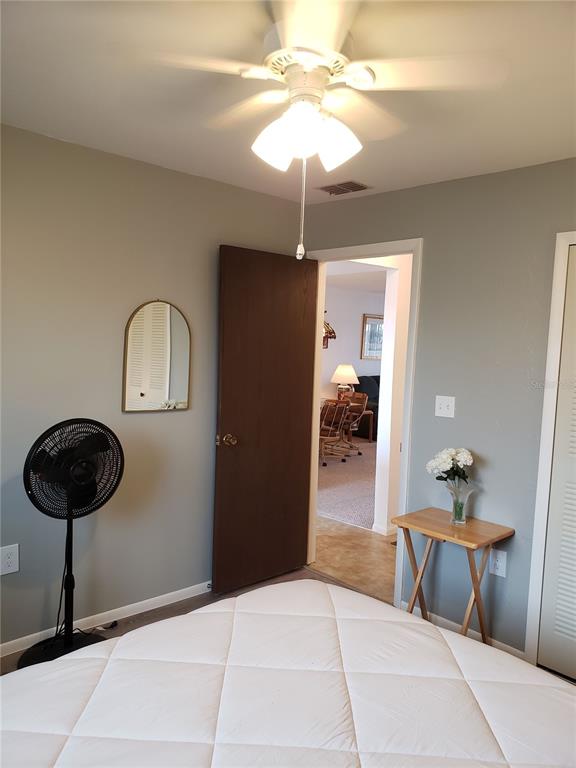 25225 Rampart Boulevard, Unit 1908 Punta Gorda, FL 33983 - Photo 12 of 15 a bedroom with a bed and a chandelier