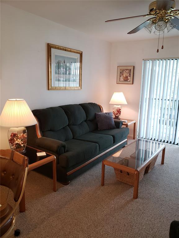 25225 Rampart Boulevard, Unit 1908 Punta Gorda, FL 33983 - Photo 6 of 15 a living room with furniture a couch and a chandelier