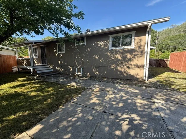 a view of a house with backyard and sitting area