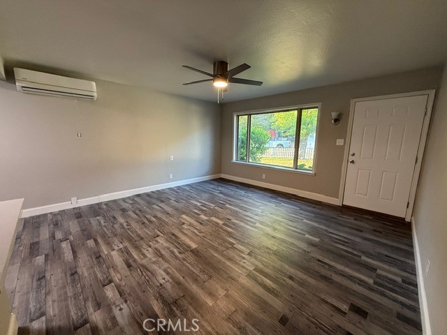 2911 Rancho Vista Drive Lucerne, CA 95458 - Photo 5 of 17 an empty room with wooden floor chandelier fan and windows