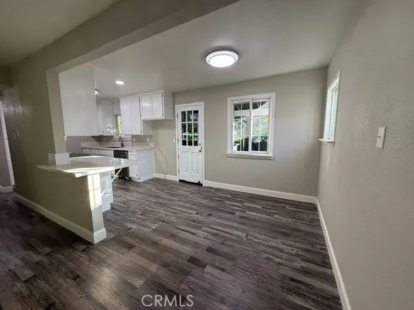 a view of kitchen and wooden floor