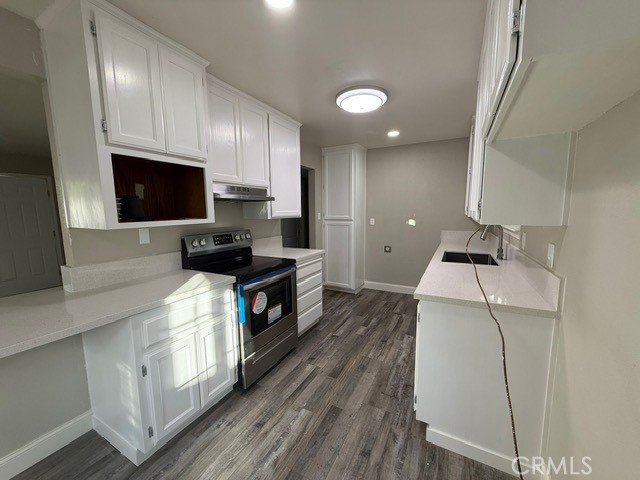 2911 Rancho Vista Drive Lucerne, CA 95458 - Photo 7 of 17 a kitchen with granite countertop a sink a stove top oven and cabinetry