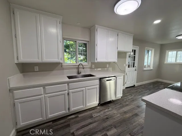 a kitchen with a sink cabinets and window