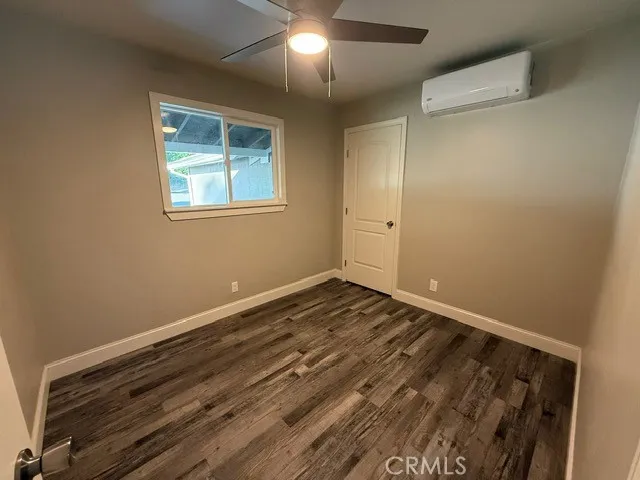 a view of a room with wooden floor and window