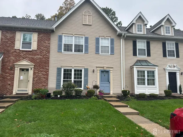 a front view of a house with a garden and plants