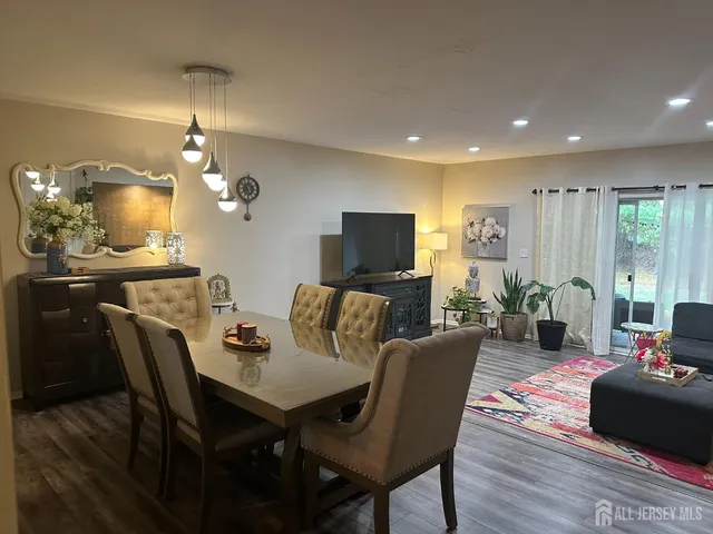 a living room with furniture a large window and a flat screen tv