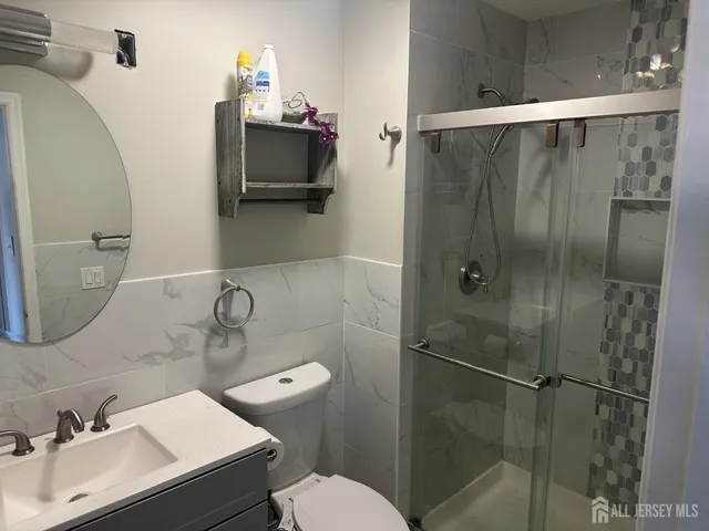 a bathroom with a sink toilet and shower