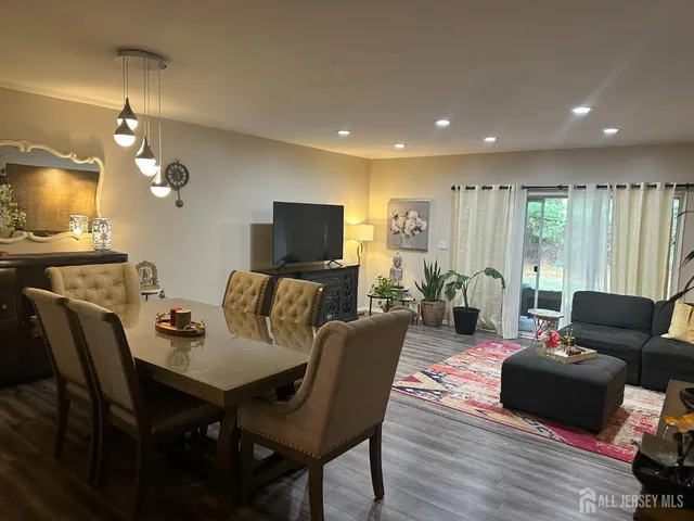 a living room with furniture a lamp and a flat screen tv