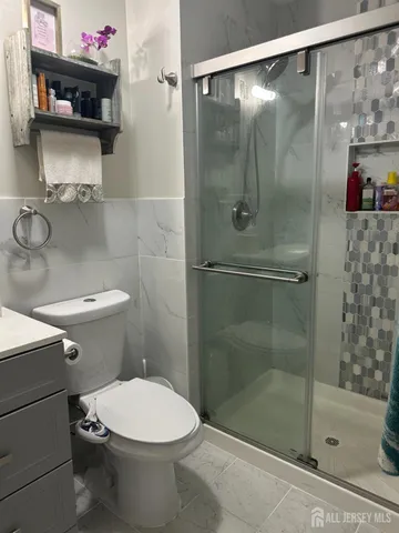 a bathroom with a toilet and a shower