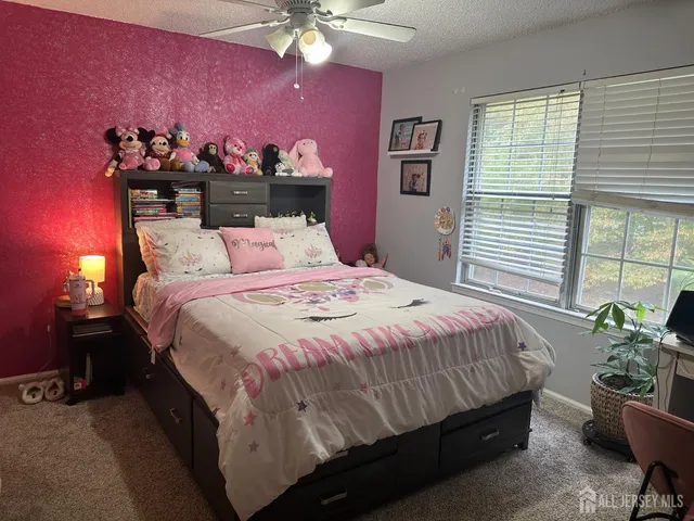 a large bed sitting in a bedroom next to a window