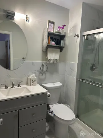 a bathroom with a sink toilet and shower