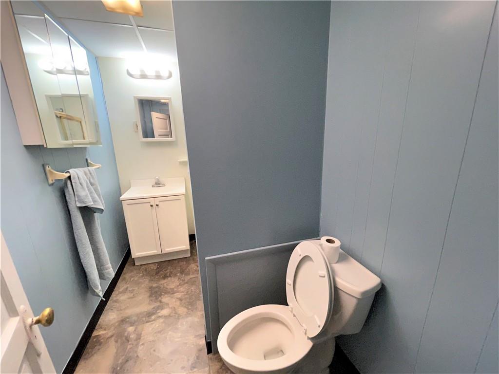 418 11th Street Beaver Falls, PA 15010 - Photo 4 of 6 a bathroom with a toilet sink and mirror