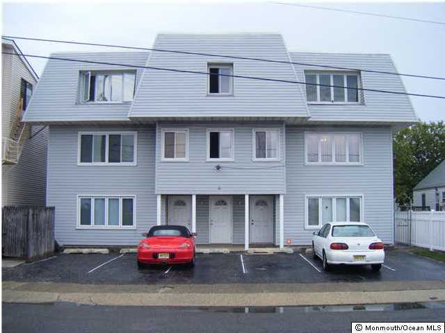 a front view of a house with parking space