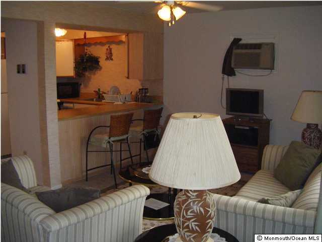 8 Bay Boulevard, Unit 3 Seaside Heights, NJ 08751 - Photo 2 of 3 a living room with furniture and a flat screen tv