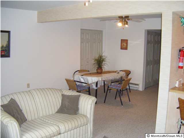 8 Bay Boulevard, Unit 3 Seaside Heights, NJ 08751 - Photo 3 of 3 a living room with furniture and a potted plant