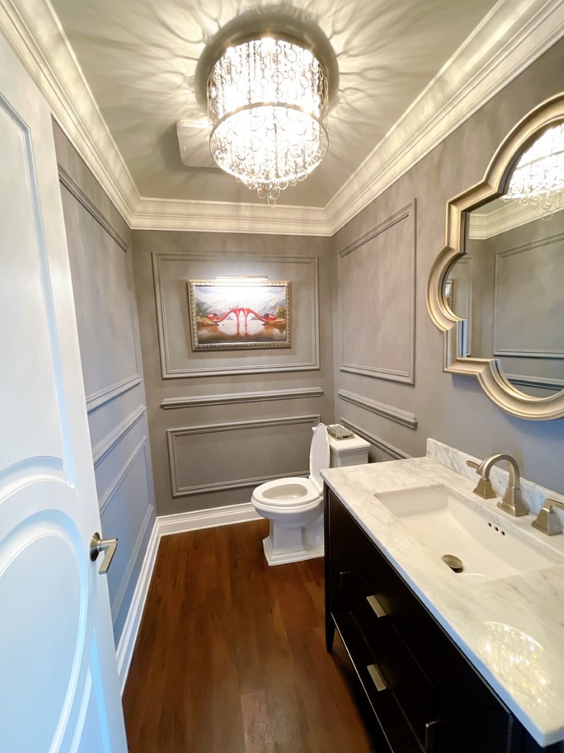 2047 Sheridan Road Buffalo Grove, IL 60089 - Photo 7 of 25 a bathroom with a sink a toilet and a mirror