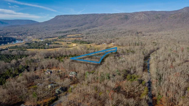 a view of a dry yard with mountains in the background