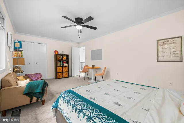 a bedroom with a bed and a tv on the dresser