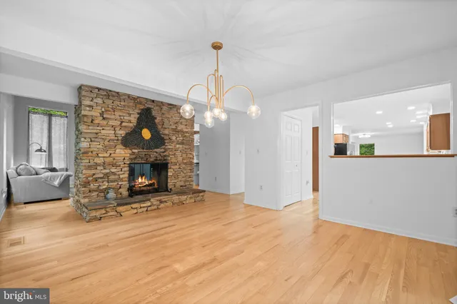 a living room with furniture wooden floor and a fireplace