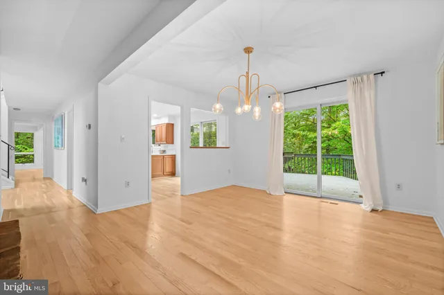 a view of a kitchen with kitchen island a sink a counter top space and stainless steel appliances
