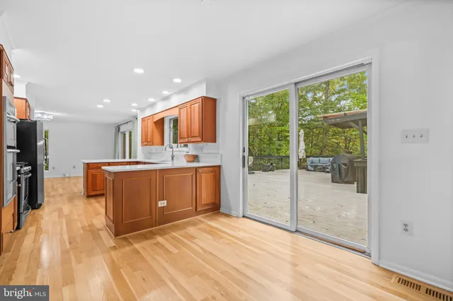a kitchen with stainless steel appliances granite countertop a refrigerator and a stove top oven