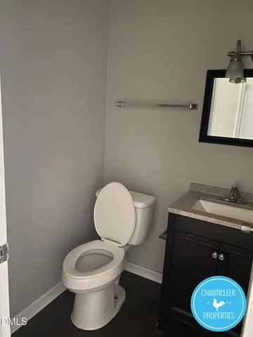a bathroom with a toilet a sink and a mirror