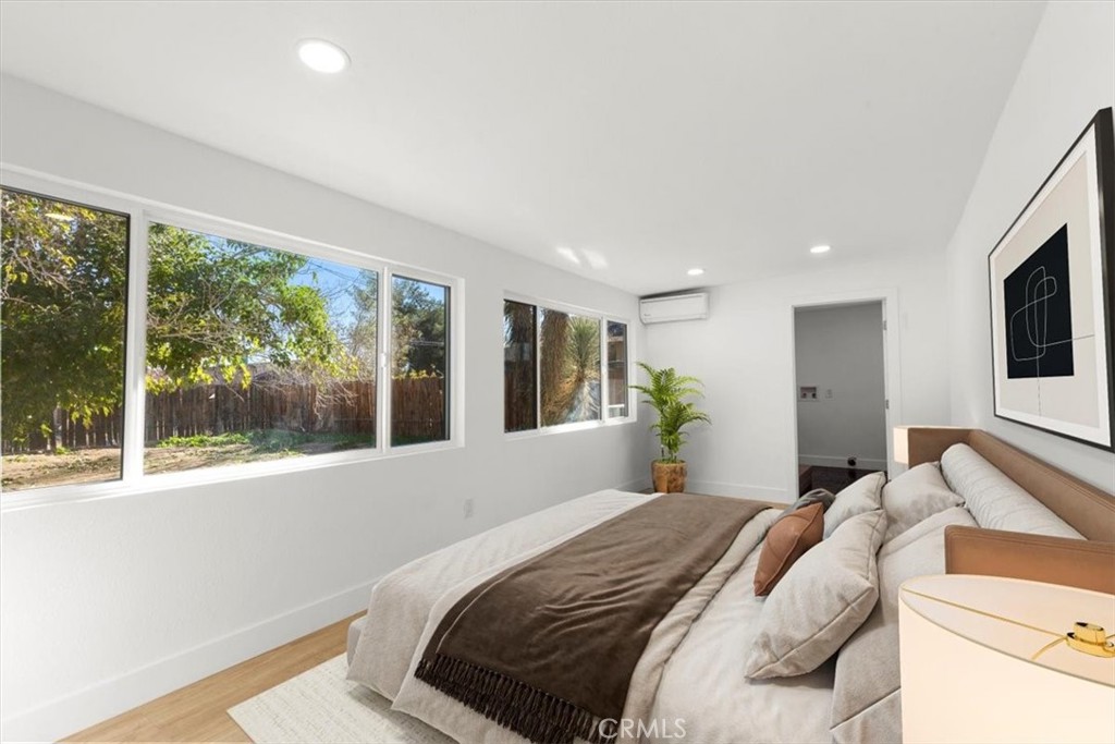 6431 Goleta Avenue Yucca Valley, CA 92284 - Photo 12 of 23 a bedroom with a large bed and a large window