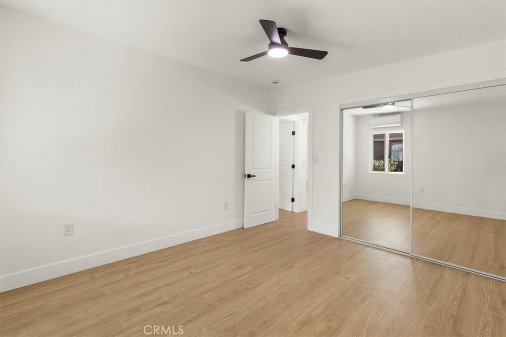 6431 Goleta Avenue Yucca Valley, CA 92284 - Photo 17 of 23 a view of empty room with wooden floor and fan