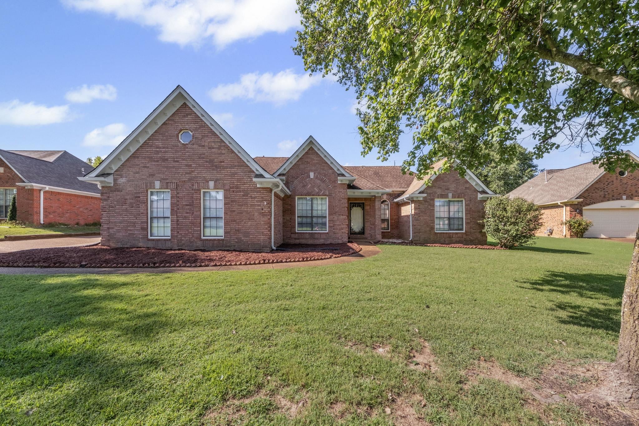 8409 Ridge Fall Cove Memphis, TN 38018 - Photo 1 of 28 View of front facade with brick siding and a front lawn