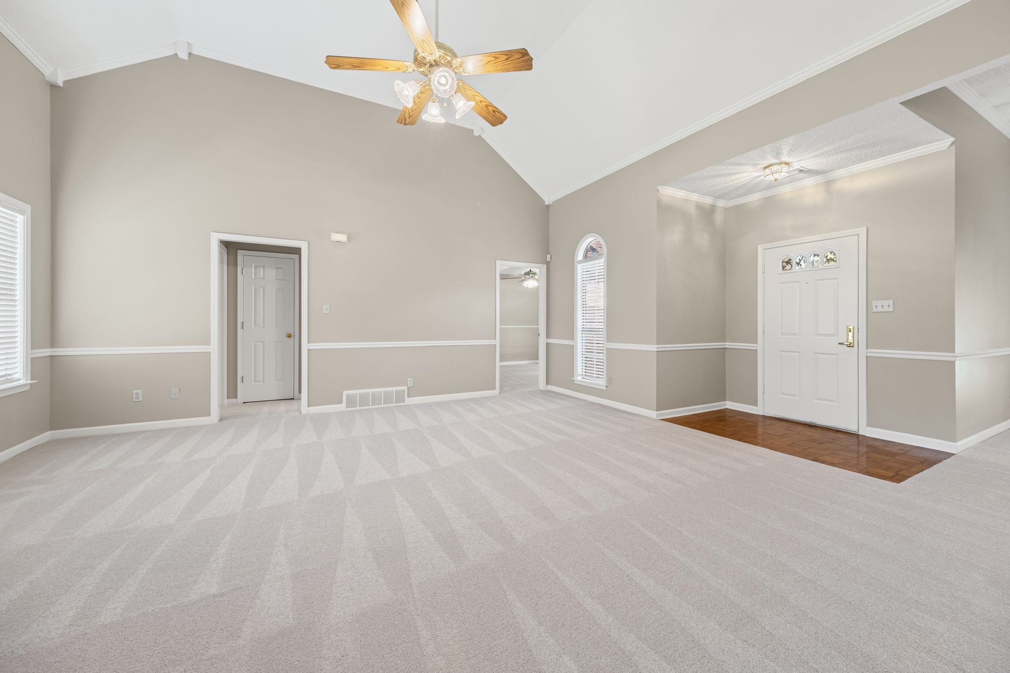 8409 Ridge Fall Cove Memphis, TN 38018 - Photo 6 of 28 Carpeted empty room with ceiling fan, vaulted ceiling, and crown molding