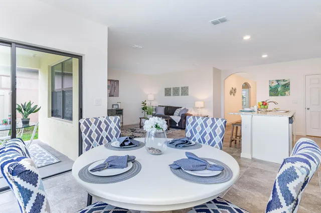 a living room with furniture and dining table