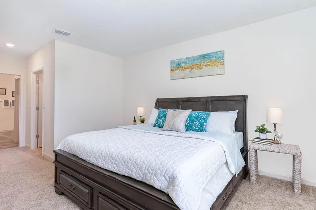 a bedroom with a bed and a table