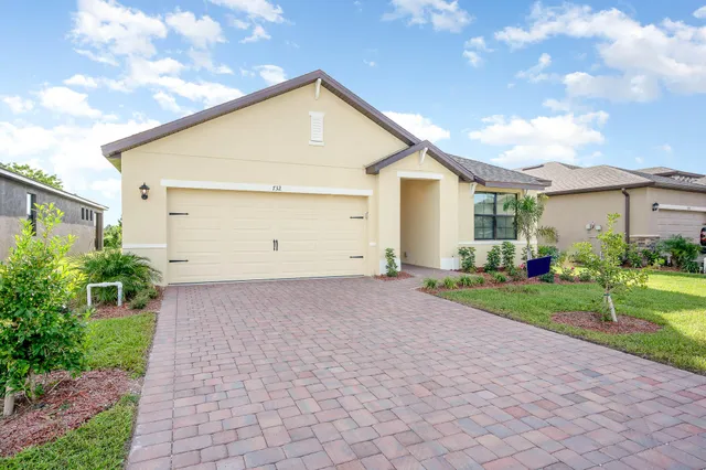 a view of house with backyard and garden