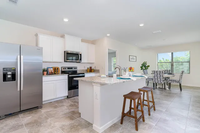 a kitchen with cabinets and stainless steel appliances