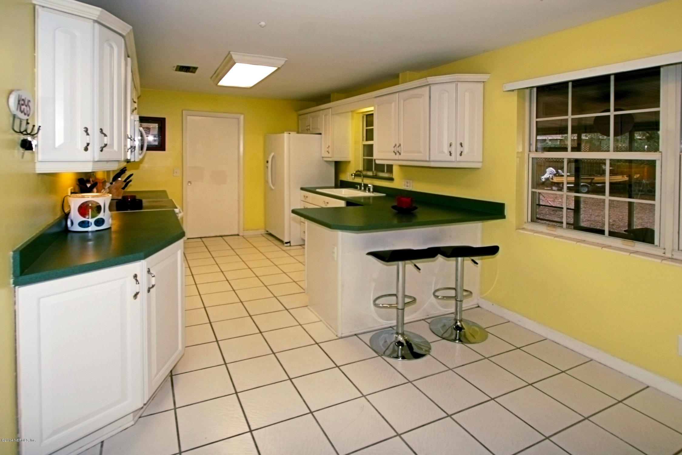 6404 Heidi Road Jacksonville, FL 32277 - Photo 11 of 26 a kitchen with stainless steel appliances a sink stove and cabinets