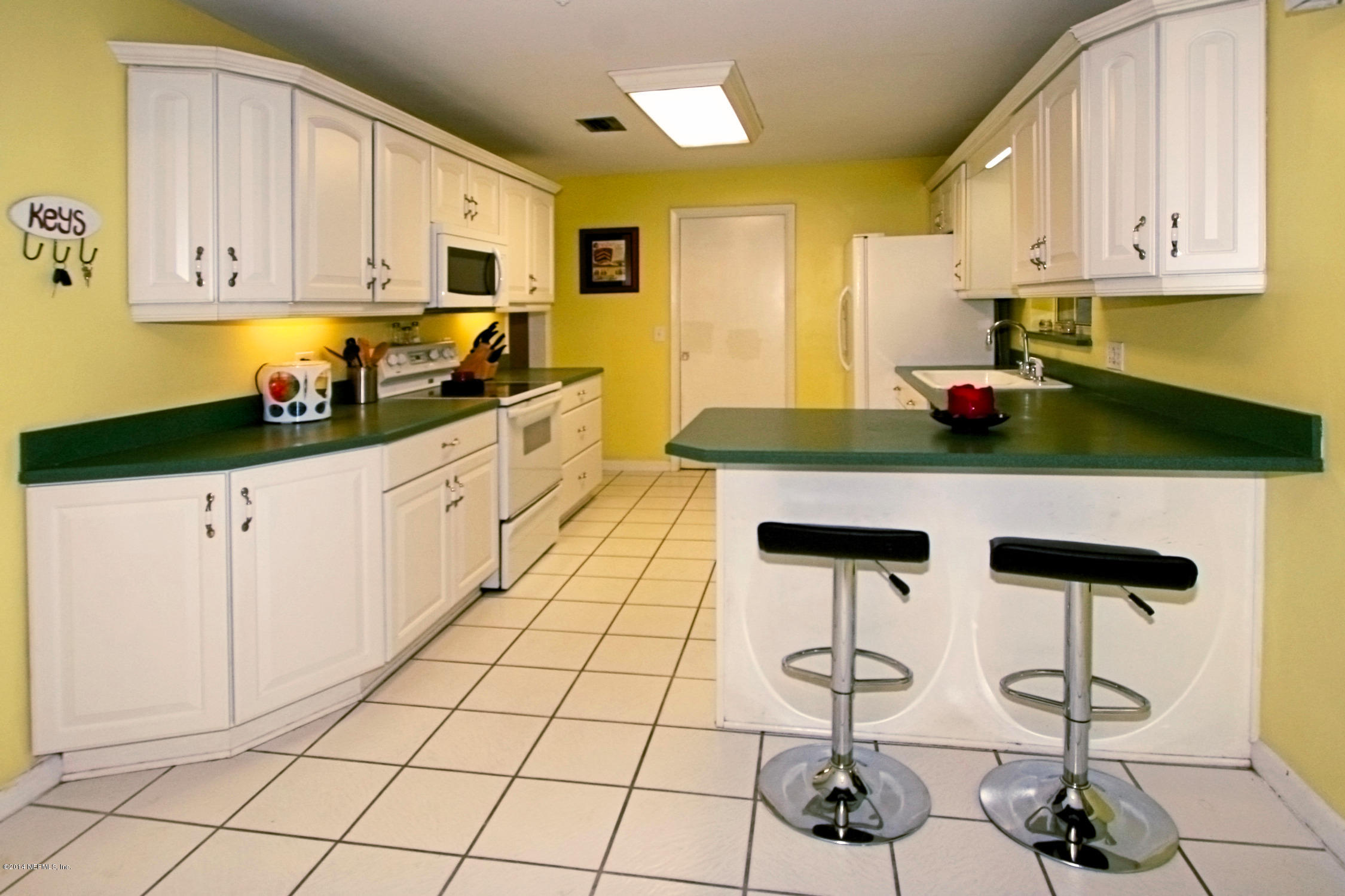 6404 Heidi Road Jacksonville, FL 32277 - Photo 12 of 26 a kitchen with stainless steel appliances a stove a sink and cabinets