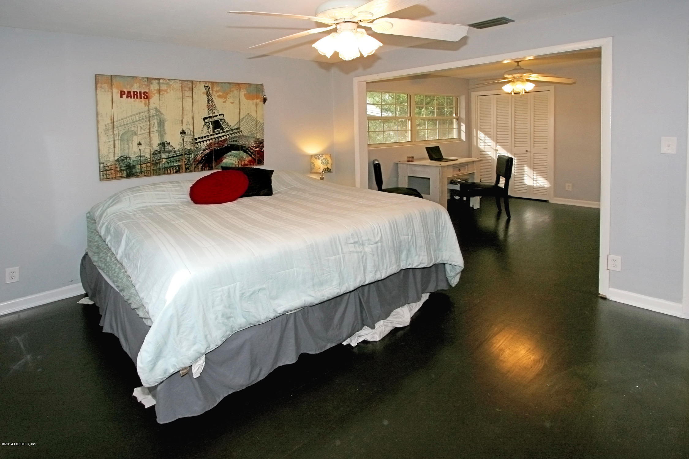 6404 Heidi Road Jacksonville, FL 32277 - Photo 16 of 26 a bed room with a bed and a chandelier