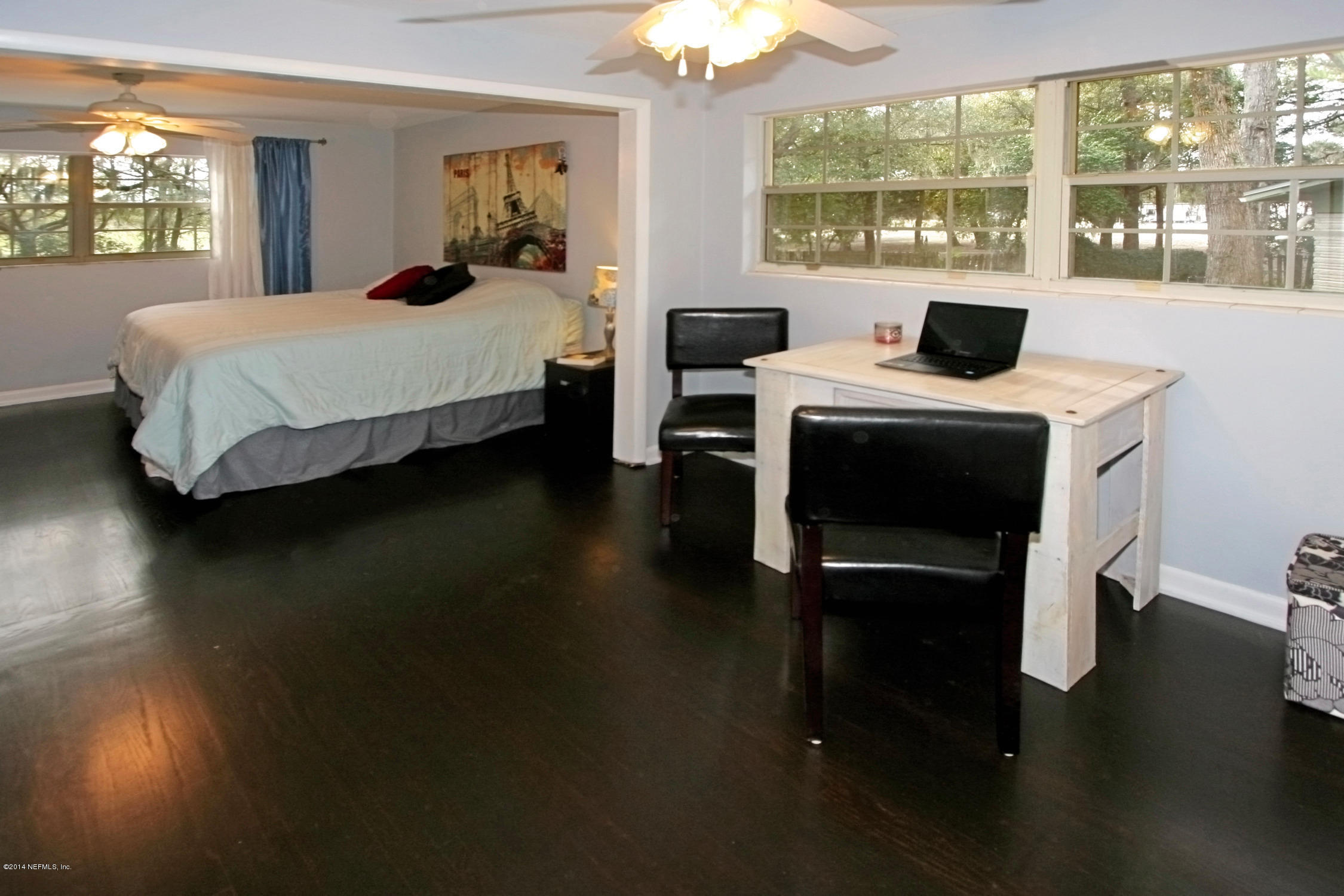 6404 Heidi Road Jacksonville, FL 32277 - Photo 17 of 26 a bedroom with a bed and wooden floor